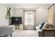 Comfortable living room featuring a large window and a cozy sofa and chair at 6176 Kingsley Dr, Indianapolis, IN 46220