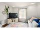 Bright living room boasts natural light, a TV with entertainment center, and comfortable seating at 6176 Kingsley Dr, Indianapolis, IN 46220