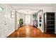 Open-concept living area with hardwood floors, neutral walls, and seamless flow to the kitchen at 6176 Kingsley Dr, Indianapolis, IN 46220