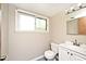 Bright bathroom with a white vanity, toilet, and blue tiled floor at 6248 Graham Rd, Indianapolis, IN 46220