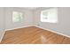 Light-filled bedroom featuring natural hardwood flooring, freshly painted walls, and windows with blinds at 6248 Graham Rd, Indianapolis, IN 46220