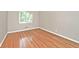 Well-lit bedroom with hardwood floors, neutral wall color, and natural light from a window at 6248 Graham Rd, Indianapolis, IN 46220
