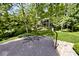 Long driveway with basketball hoop surrounded by mature trees on a sprawling lot, perfect for Gathering fun and outdoor activities at 6248 Graham Rd, Indianapolis, IN 46220