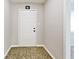 Inviting entryway with a front door and neutral tones, leading into a carpeted interior space at 6248 Graham Rd, Indianapolis, IN 46220
