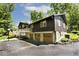 Exterior showing 3-car garage, expansive driveway, back deck and spacious yard surrounded by lush mature trees on this stunning property at 6248 Graham Rd, Indianapolis, IN 46220