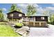 Multi-level home showcasing a private setting, 3-car garage, and a beautiful front yard with stone walkway and plenty of lush trees at 6248 Graham Rd, Indianapolis, IN 46220