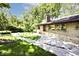 Landscaped front of a stone home with a view of the lush lawn and surroundings on a sunny day at 6248 Graham Rd, Indianapolis, IN 46220