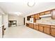 Bright kitchen featuring wood cabinets, a built-in oven, and view to adjacent living area at 6248 Graham Rd, Indianapolis, IN 46220