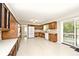 Bright kitchen with wood cabinets, white appliances, and sliding glass door to the deck at 6248 Graham Rd, Indianapolis, IN 46220