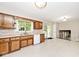 Open kitchen featuring wood cabinets, a window over the sink, and sliding door to the deck at 6248 Graham Rd, Indianapolis, IN 46220