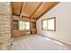 A bright room with a stone fireplace, wood beamed ceiling, built-in storage, and sun-filled windows at 6248 Graham Rd, Indianapolis, IN 46220