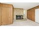 Cozy living room featuring a stone fireplace and wood paneled walls at 6248 Graham Rd, Indianapolis, IN 46220