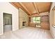 Open living space featuring a stone fireplace, wood ceiling, and built-in shelves for a cozy atmosphere at 6248 Graham Rd, Indianapolis, IN 46220