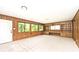 Large living room featuring built-in bookcases, wood-panelled walls, and direct access to the yard at 6248 Graham Rd, Indianapolis, IN 46220
