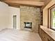 Bright living room with stone fireplace, built-in shelving and cabinets, and a large window at 6248 Graham Rd, Indianapolis, IN 46220