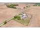 An aerial perspective showcases a farm with a house, multiple outbuildings, storage silos, and surrounding farmland at 671 W 350 N, Shelbyville, IN 46176
