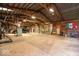 Large barn interior featuring ample storage, lighting, and workspace with an expansive concrete floor and metal beam ceiling at 671 W 350 N, Shelbyville, IN 46176