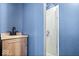 Blue bathroom featuring a modern vanity and glass-enclosed shower at 671 W 350 N, Shelbyville, IN 46176