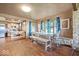 Charming dining area with hardwood floors, rustic stone wall, natural light, and a view into the kitchen at 671 W 350 N, Shelbyville, IN 46176