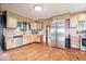 Charming kitchen featuring stainless appliances, wood floors and unique stone backsplash at 671 W 350 N, Shelbyville, IN 46176