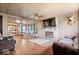 Spacious living room with hardwood floors, a stone fireplace, natural light, and comfortable seating at 671 W 350 N, Shelbyville, IN 46176