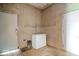 Functional utility room with concrete block walls, concrete floors, and storage space for a chest freezer and other equipment at 671 W 350 N, Shelbyville, IN 46176