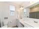 Bright bathroom with double sinks, white cabinets and a modern mirror with decorative lighting and decor at 6832 Oakcrest Dr, McCordsville, IN 46055