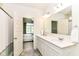Bright bathroom featuring double sinks and an open doorway to a bedroom, offering convenience and style at 6832 Oakcrest Dr, McCordsville, IN 46055