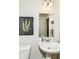 Charming powder room featuring a pedestal sink and wall decor, creating a welcoming space at 6832 Oakcrest Dr, McCordsville, IN 46055