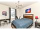 Modern bedroom featuring a workspace, bed, and striking artwork, designed for productivity and relaxation at 6832 Oakcrest Dr, McCordsville, IN 46055
