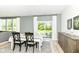 Bright dining area with a sliding glass door, stylish table setting, and wood-look flooring at 6832 Oakcrest Dr, McCordsville, IN 46055