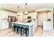 Modern kitchen featuring white cabinets, stainless steel appliances, and a center island with seating at 6832 Oakcrest Dr, McCordsville, IN 46055