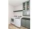 Well-organized laundry room with modern appliances and storage cabinets, perfect for efficient chores at 6832 Oakcrest Dr, McCordsville, IN 46055