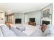 Expansive living room showcasing a fireplace, piano, and comfortable grey sectional sofa at 6832 Oakcrest Dr, McCordsville, IN 46055