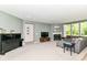 Spacious living area featuring a cozy fireplace, grand piano, and comfortable seating arrangement at 6832 Oakcrest Dr, McCordsville, IN 46055