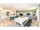 Open-concept living space with a kitchen island, dining table, and comfortable seating area at 6832 Oakcrest Dr, McCordsville, IN 46055