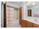 Bathroom with neutral shower/bath, toilet, vanity, and linen closet at 7135 Huntington Rd, Indianapolis, IN 46240