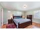 Bedroom featuring a queen bed, hardwood floors, and lots of light from the windows at 7135 Huntington Rd, Indianapolis, IN 46240