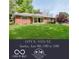 Charming single-story brick home with a well-manicured lawn and mature trees at 7135 Huntington Rd, Indianapolis, IN 46240