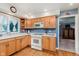 Well-lit kitchen featuring plenty of wood cabinetry and bright countertops at 7135 Huntington Rd, Indianapolis, IN 46240