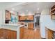 Charming kitchen features wood cabinets, stainless appliances, peninsula counter, and hardwood floors at 7135 Huntington Rd, Indianapolis, IN 46240