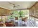 Screened-in porch with comfortable seating and views of the backyard at 7135 Huntington Rd, Indianapolis, IN 46240