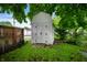 White shed in a green backyard, providing additional storage or workspace at 732 S Biltmore Ave, Indianapolis, IN 46241
