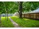 Lush backyard with mature tree and green grass, ideal for enjoying the outdoors at 732 S Biltmore Ave, Indianapolis, IN 46241