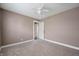 Neutral painted bedroom with plush carpeting and a ceiling fan, creating a comfortable space at 732 S Biltmore Ave, Indianapolis, IN 46241