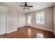 Bedroom featuring laminate floors, ceiling fan, a window, and a door leading to the backyard at 732 S Biltmore Ave, Indianapolis, IN 46241