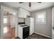 Cozy kitchen with white cabinets, gas range, and refrigerator, offering functionality and a classic aesthetic at 732 S Biltmore Ave, Indianapolis, IN 46241