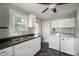 Practical laundry room with washer, dryer, sink, and ample counter space and storage for convenience at 732 S Biltmore Ave, Indianapolis, IN 46241