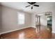 Inviting living room featuring gleaming hardwood floors, an archway, and abundant natural light streaming through the windows at 732 S Biltmore Ave, Indianapolis, IN 46241
