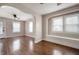 Inviting living room featuring gleaming hardwood floors, an archway, and abundant natural light streaming through the windows at 732 S Biltmore Ave, Indianapolis, IN 46241